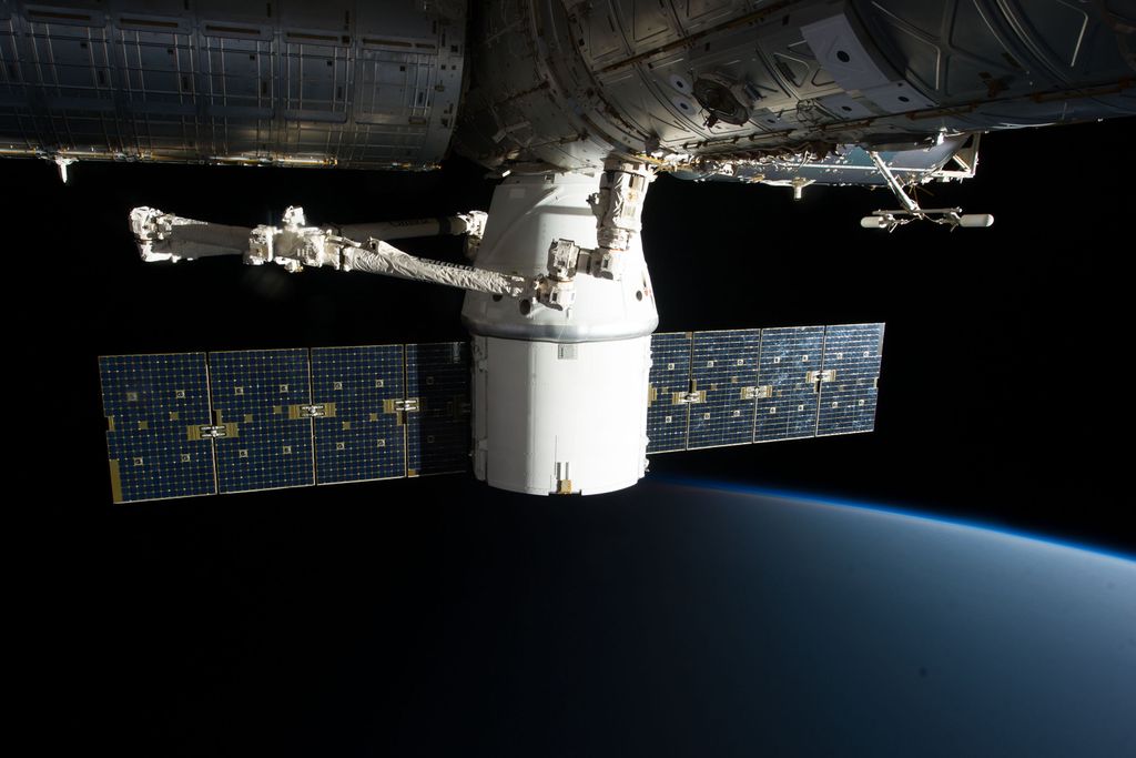 MASON JOURNAL Image of the International Space Station floating above Earth with visible solar panels.